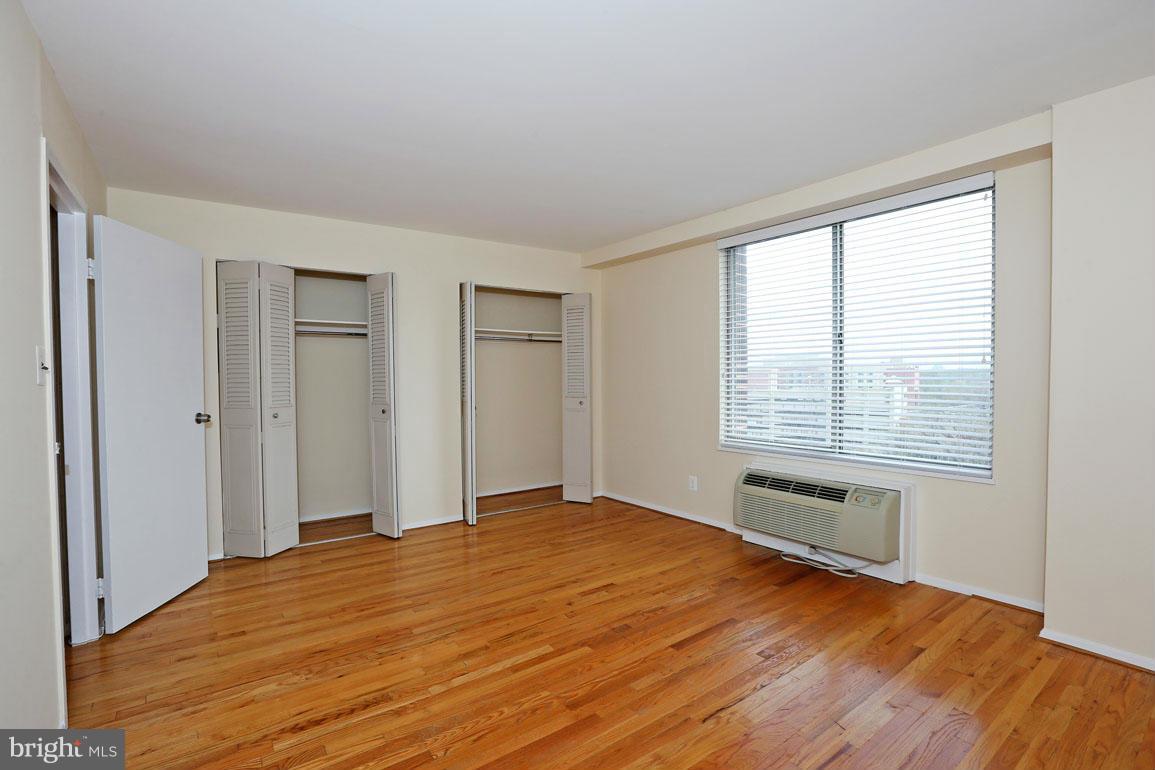 9701 Fields Road, Unit 603 Gaithersburg, MD 20878 - Photo 18 of 29 a view of an empty room with wooden floor and a window