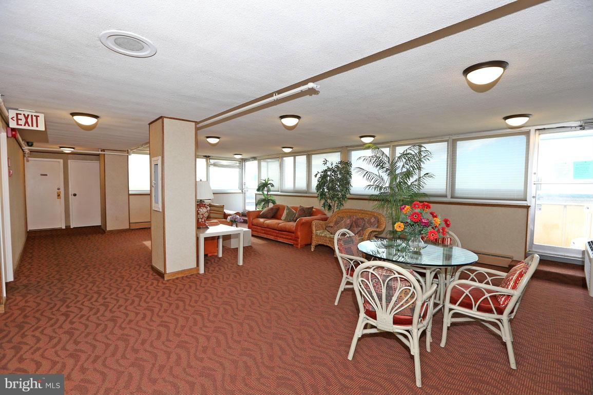 9701 Fields Road, Unit 603 Gaithersburg, MD 20878 - Photo 24 of 29 a view of a dining room with furniture and a floor to ceiling window
