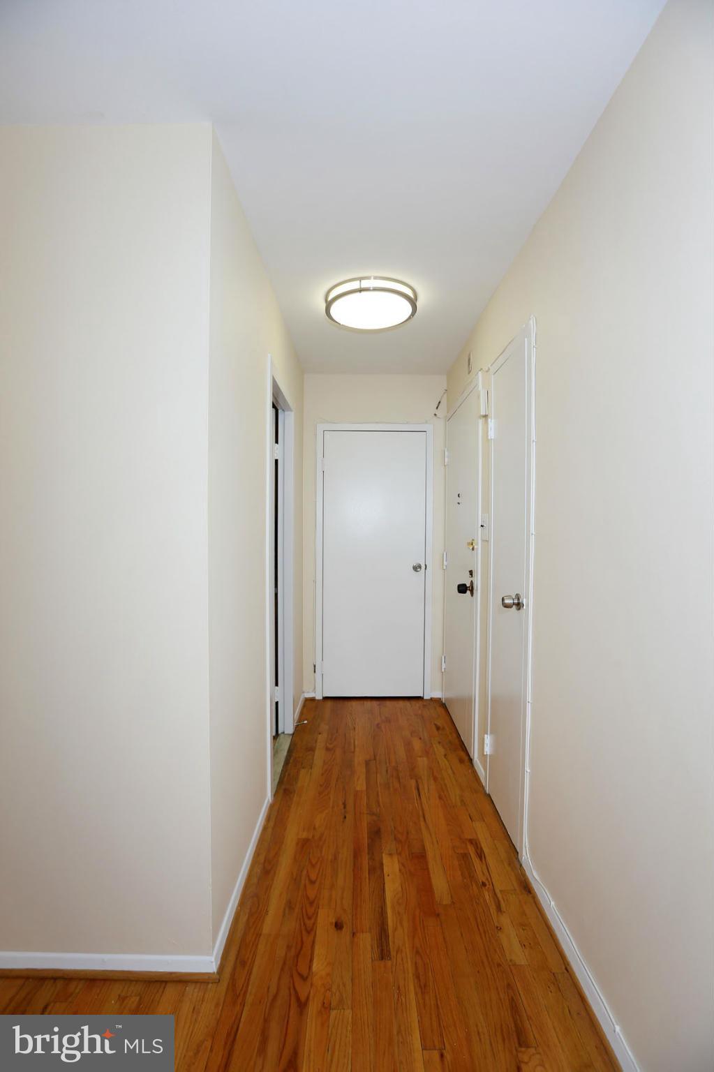 9701 Fields Road, Unit 603 Gaithersburg, MD 20878 - Photo 5 of 29 a view of a hallway with wooden floor