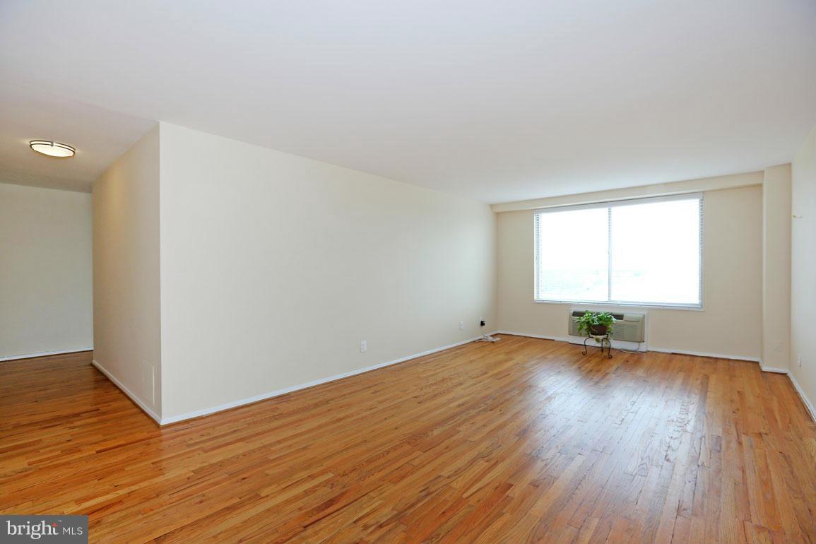 9701 Fields Road, Unit 603 Gaithersburg, MD 20878 - Photo 6 of 29 an empty room with wooden floor and windows