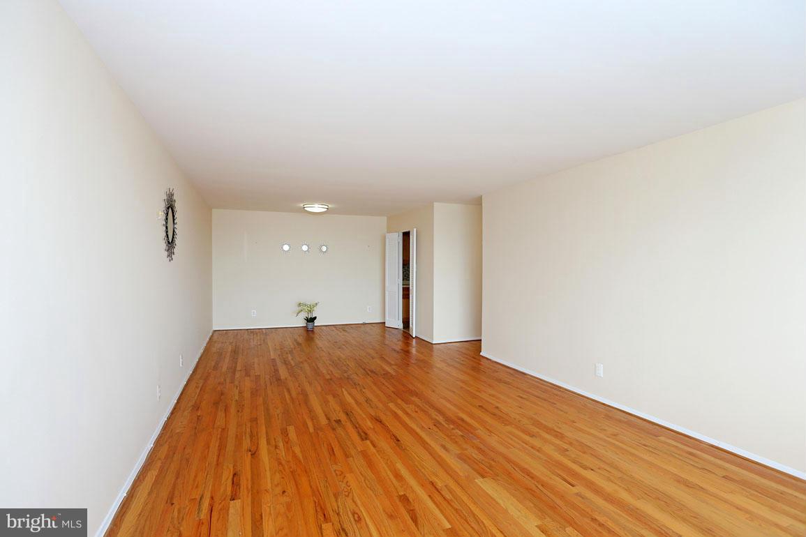 9701 Fields Road, Unit 603 Gaithersburg, MD 20878 - Photo 7 of 29 a view of empty room with wooden floor