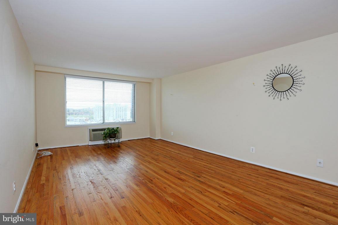 9701 Fields Road, Unit 603 Gaithersburg, MD 20878 - Photo 8 of 29 an empty room with wooden floor and windows