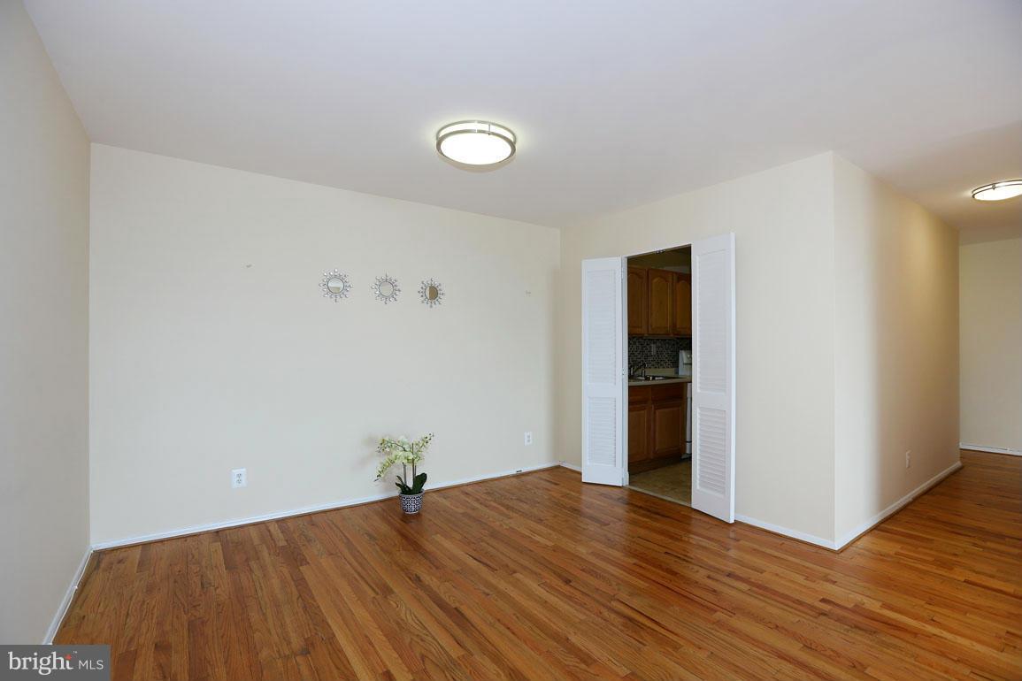 9701 Fields Road, Unit 603 Gaithersburg, MD 20878 - Photo 9 of 29 a view of a livingroom with wooden floor and closet