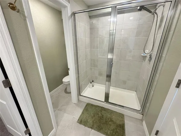 a bathroom with a shower and a toilet