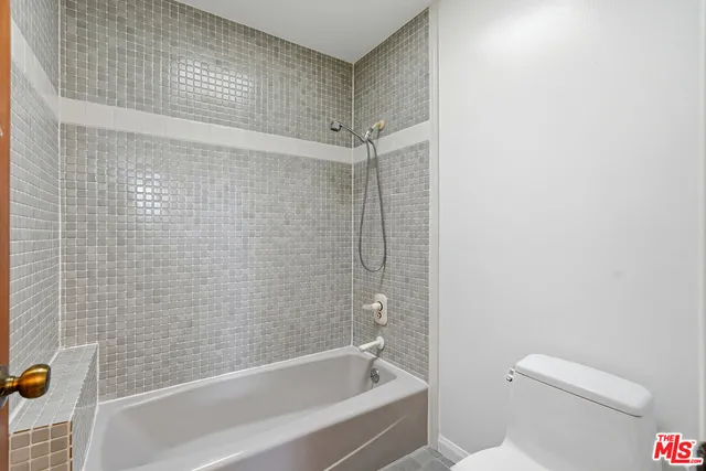 a bathroom with a shower and a toilet