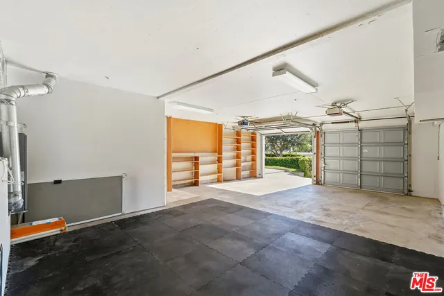 a view of an empty room with a fireplace and a window