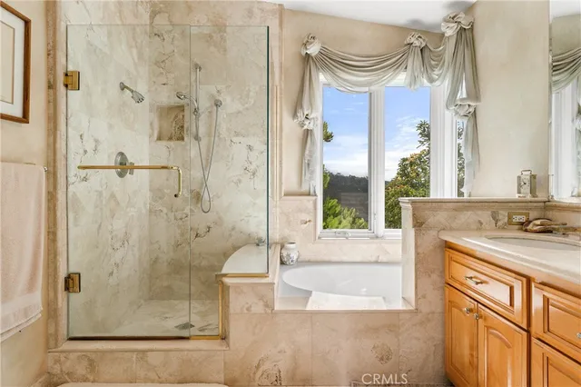 a bathroom with a granite countertop sink a mirror and a shower