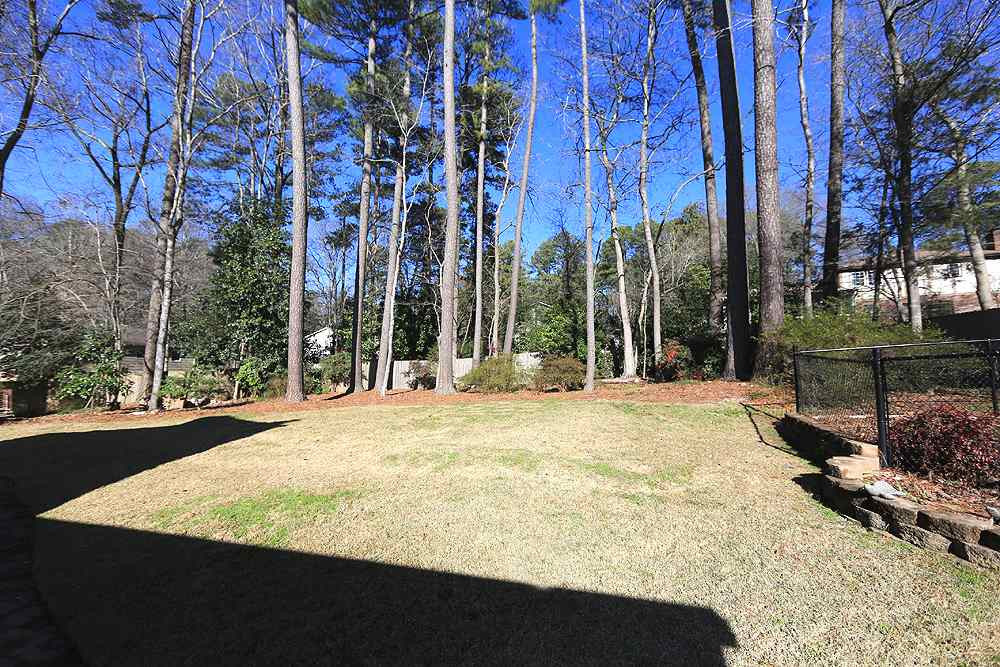 4305 Oak Park Road Raleigh, NC 27612 - Photo 14 of 18 Look at this backyard! There is a 6' Seegars fence, zoysia grass, and mature hardwoods plus some landscaped plantings with pine needle mulch. Which way does the house face? This picture was taken at about 10A on 1/28/20. By my estimation it faces SE Exterior Back