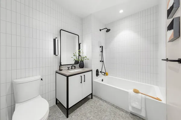 a bathroom with a sink a toilet and shower