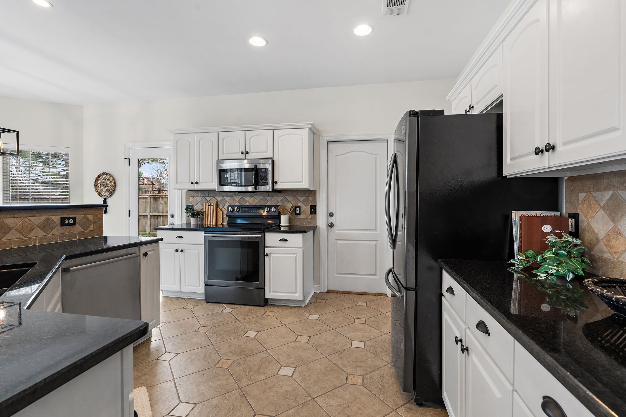 3140 Vera Valley Road Franklin, TN 37064 - Photo 13 of 38 a kitchen with granite countertop a refrigerator stove and sink
