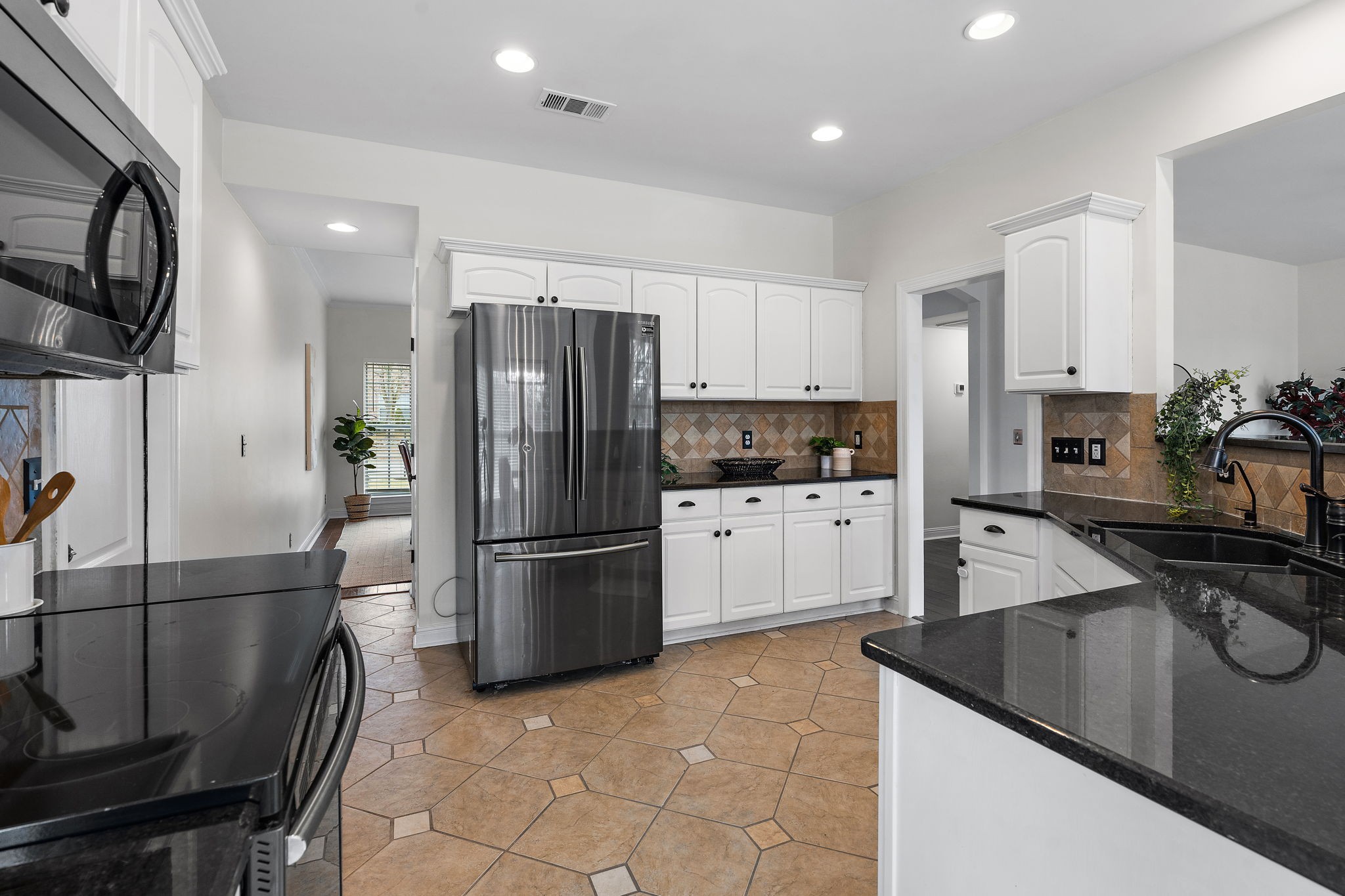 3140 Vera Valley Road Franklin, TN 37064 - Photo 15 of 38 a kitchen with stainless steel appliances granite countertop a refrigerator a stove a sink and a microwave