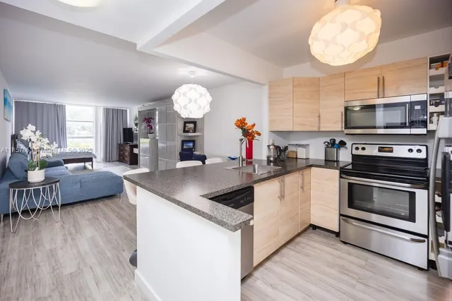 a kitchen with stainless steel appliances granite countertop a stove and a sink