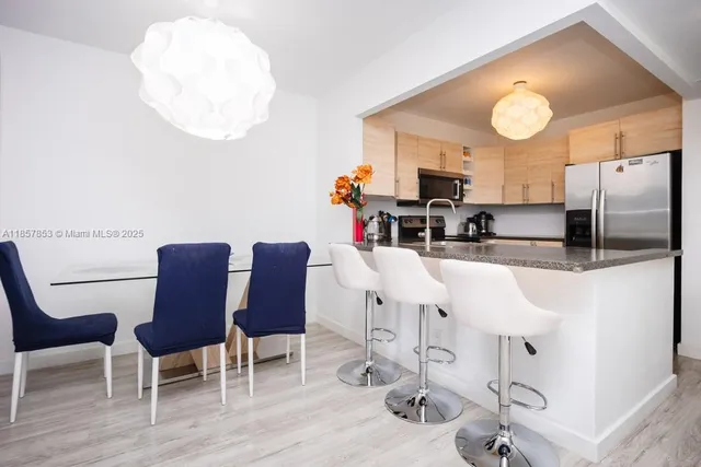 a kitchen with cabinets and chairs