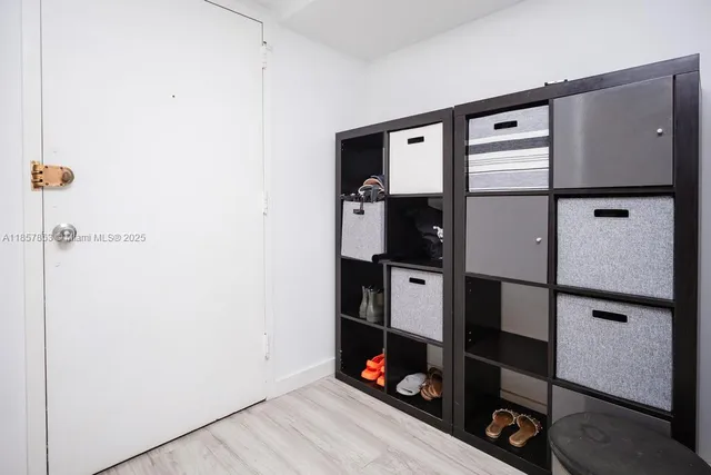 a view of a hallway with workspace and closet