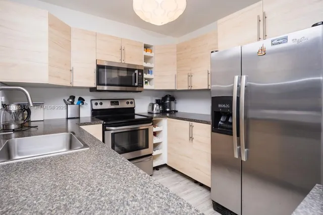 a kitchen with a refrigerator stove and microwave