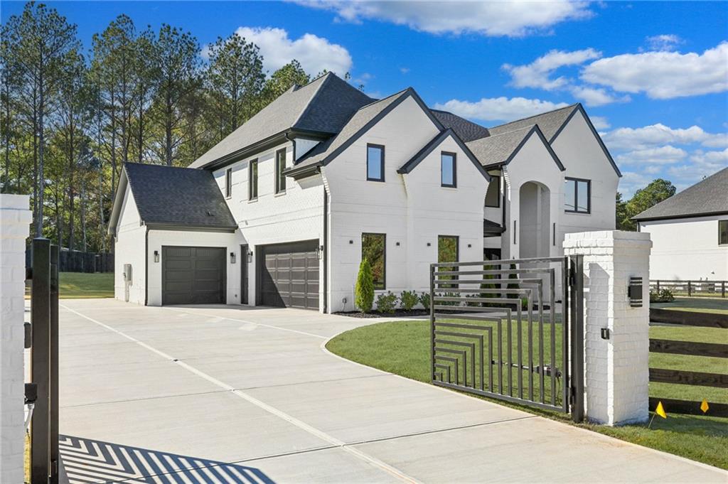 3207 Bold Springs Road Dacula, GA 30019 - Photo 2 of 67 a view of a white house with large trees and playing area in front of it