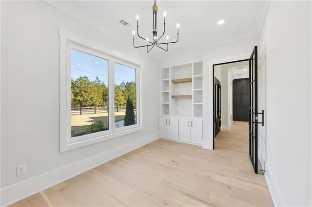 a view of a room with a windows and ceiling fan