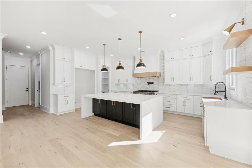 3207 Bold Springs Road Dacula, GA 30019 - Photo 24 of 67 a large kitchen with a large counter top a sink stainless steel appliances and cabinets