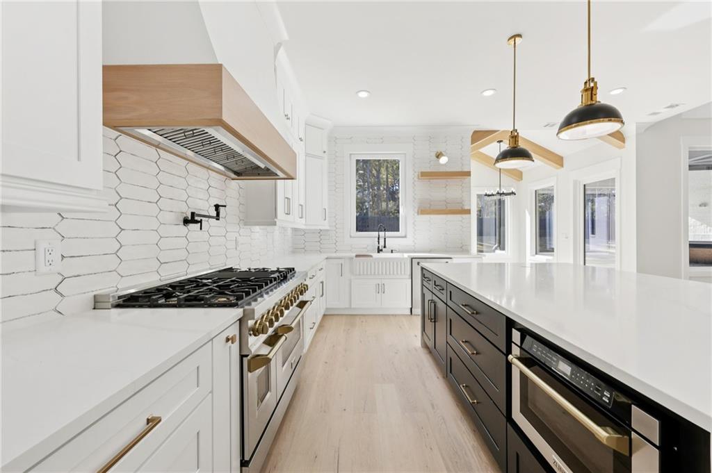 3207 Bold Springs Road Dacula, GA 30019 - Photo 28 of 67 a kitchen with stainless steel appliances granite countertop a stove a sink and a wooden floors