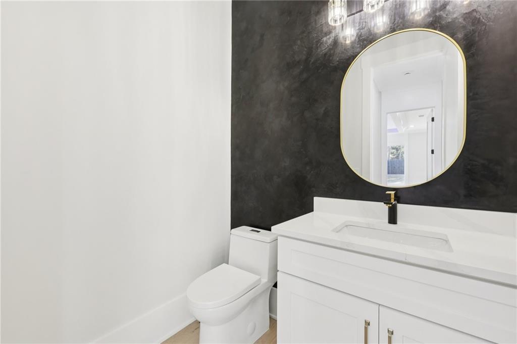 3207 Bold Springs Road Dacula, GA 30019 - Photo 33 of 67 a bathroom with a toilet sink and mirror