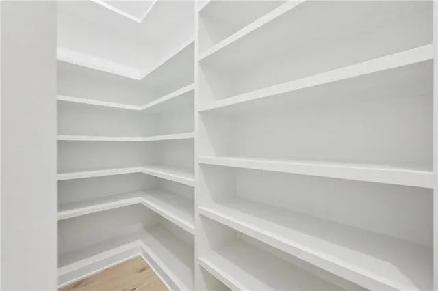 a view of a livingroom with a ceiling fan & window
