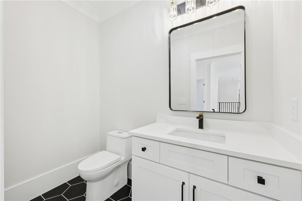 3207 Bold Springs Road Dacula, GA 30019 - Photo 48 of 67 a bathroom with a toilet sink and mirror