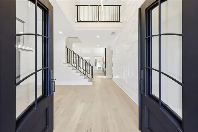 a view of a big room with windows and chandelier