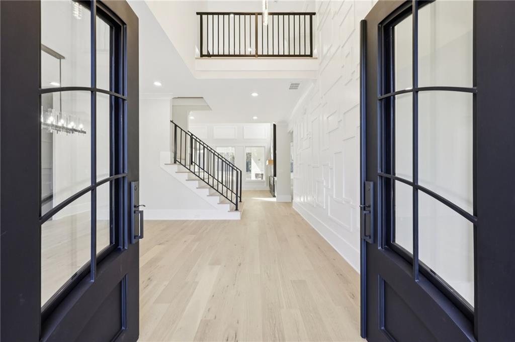 3207 Bold Springs Road Dacula, GA 30019 - Photo 5 of 67 a view of staircase with lots of frames on wall and a potted plant