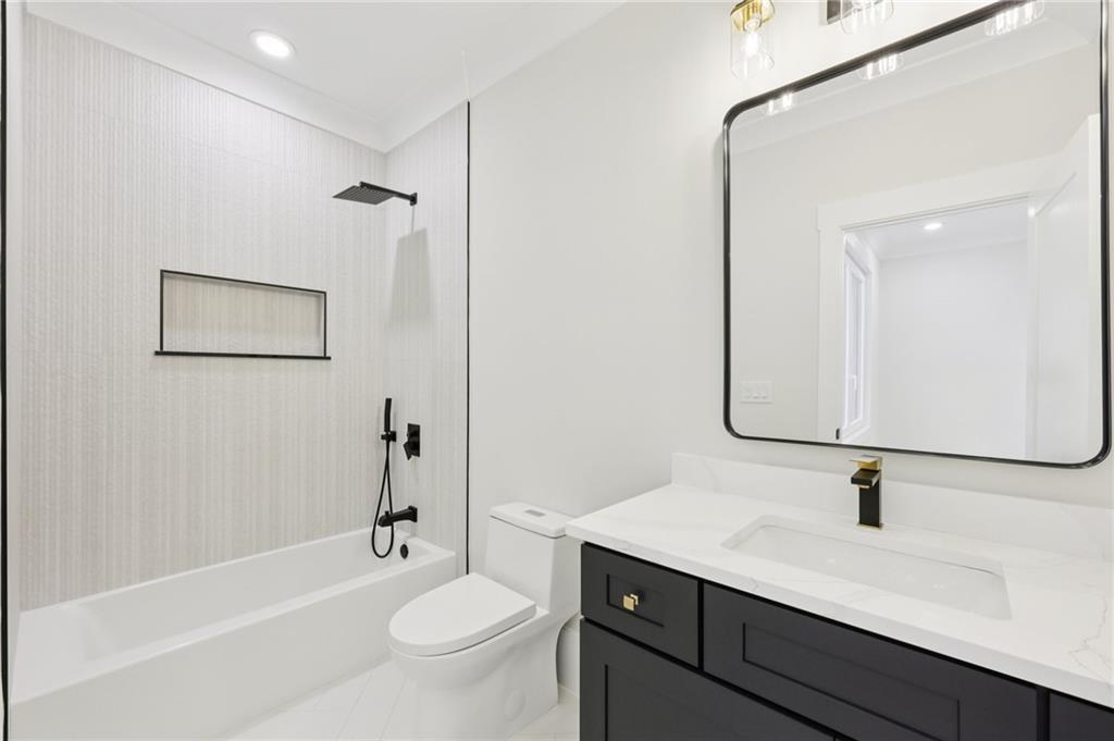 3207 Bold Springs Road Dacula, GA 30019 - Photo 57 of 67 a bathroom with a bathtub shower sink vanity mirror and toilet