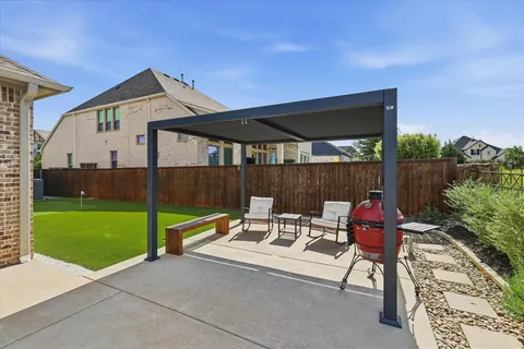 a view of house with backyard outdoor seating and hardwood