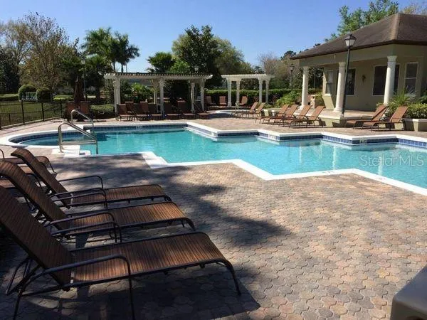 a view of a house with swimming pool and porch with furniture
