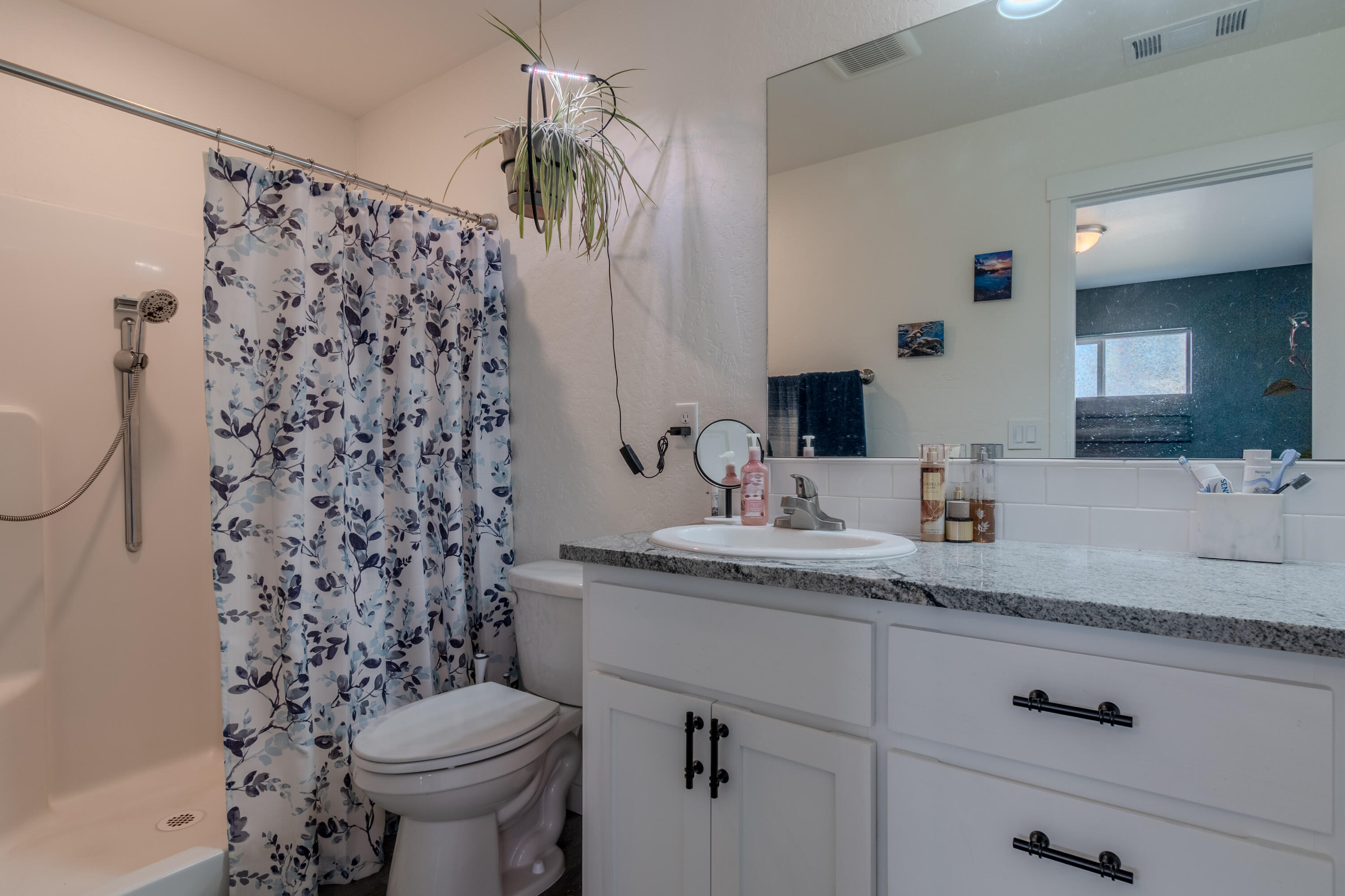 21 Cerulean Terrace Eagle Point, OR 97524 - Photo 21 of 30 a bathroom with a granite countertop sink and a toilet