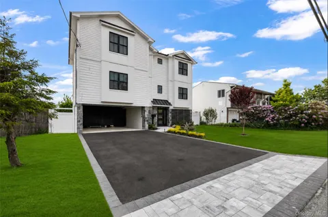 a view of a white house with a yard