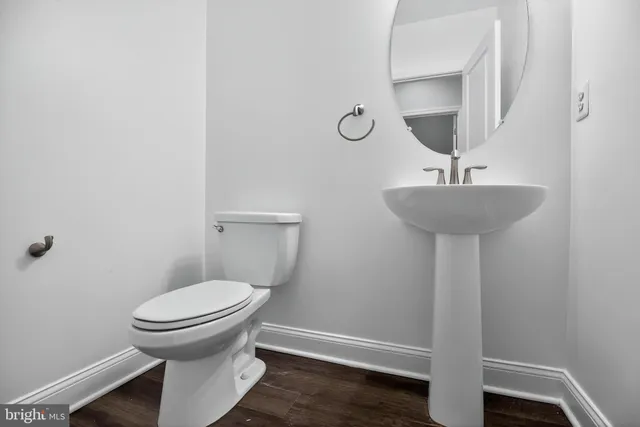 a bathroom with a sink toilet and a mirror