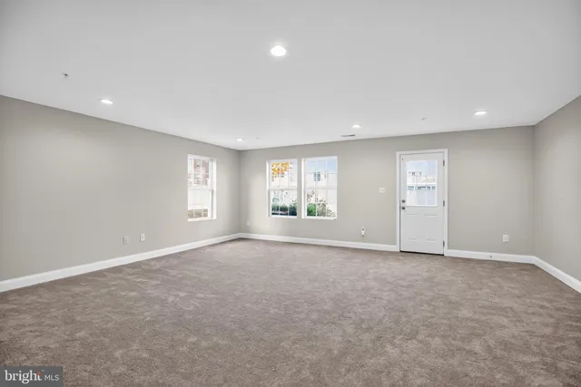 an empty room with windows and closet