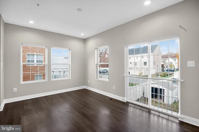 a view of a kitchen with wooden floor and a window
