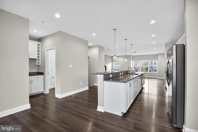 a large kitchen with a lot of counter space and stainless steel appliances
