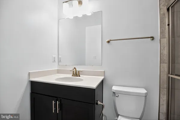 a bathroom with a sink a toilet and a mirror