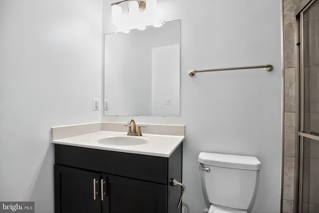 a bathroom with a sink a toilet and a mirror