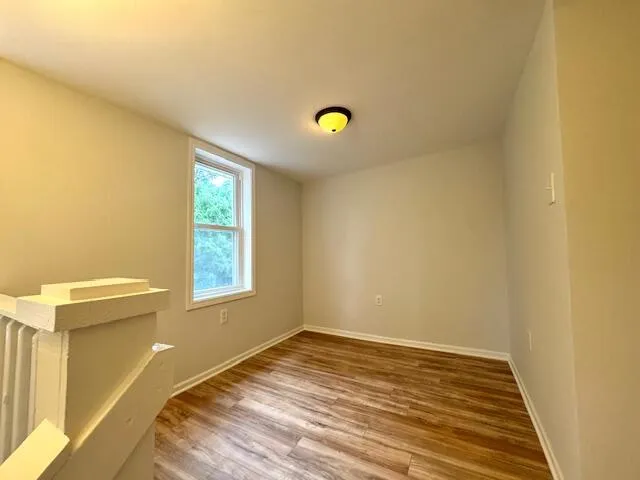 a view of a room with window and wooden floor