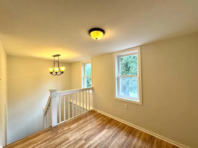 a view of a room with window and wooden floor