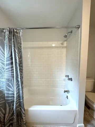 a bathroom with a shower and a bathtub