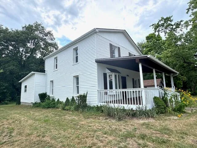 a view of a house with a yard and plants