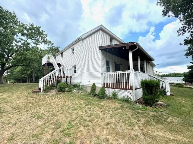 a view of a house with a yard and plants
