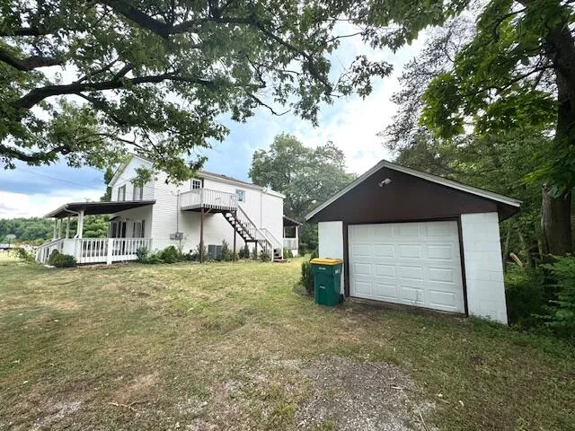a white house that has a tree in front of it
