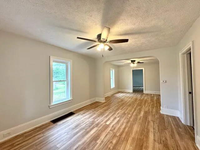 wooden floor in an empty room with a window