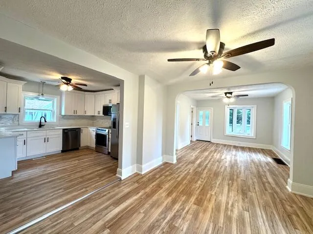 a view of a kitchen with a sink wooden floor and a kitchen