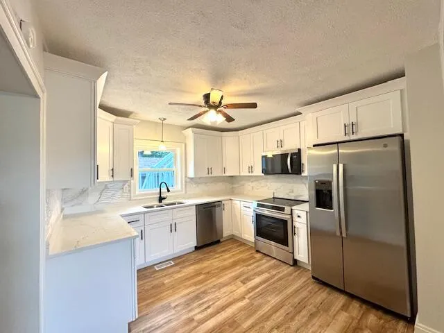 a kitchen with a sink stove and refrigerator