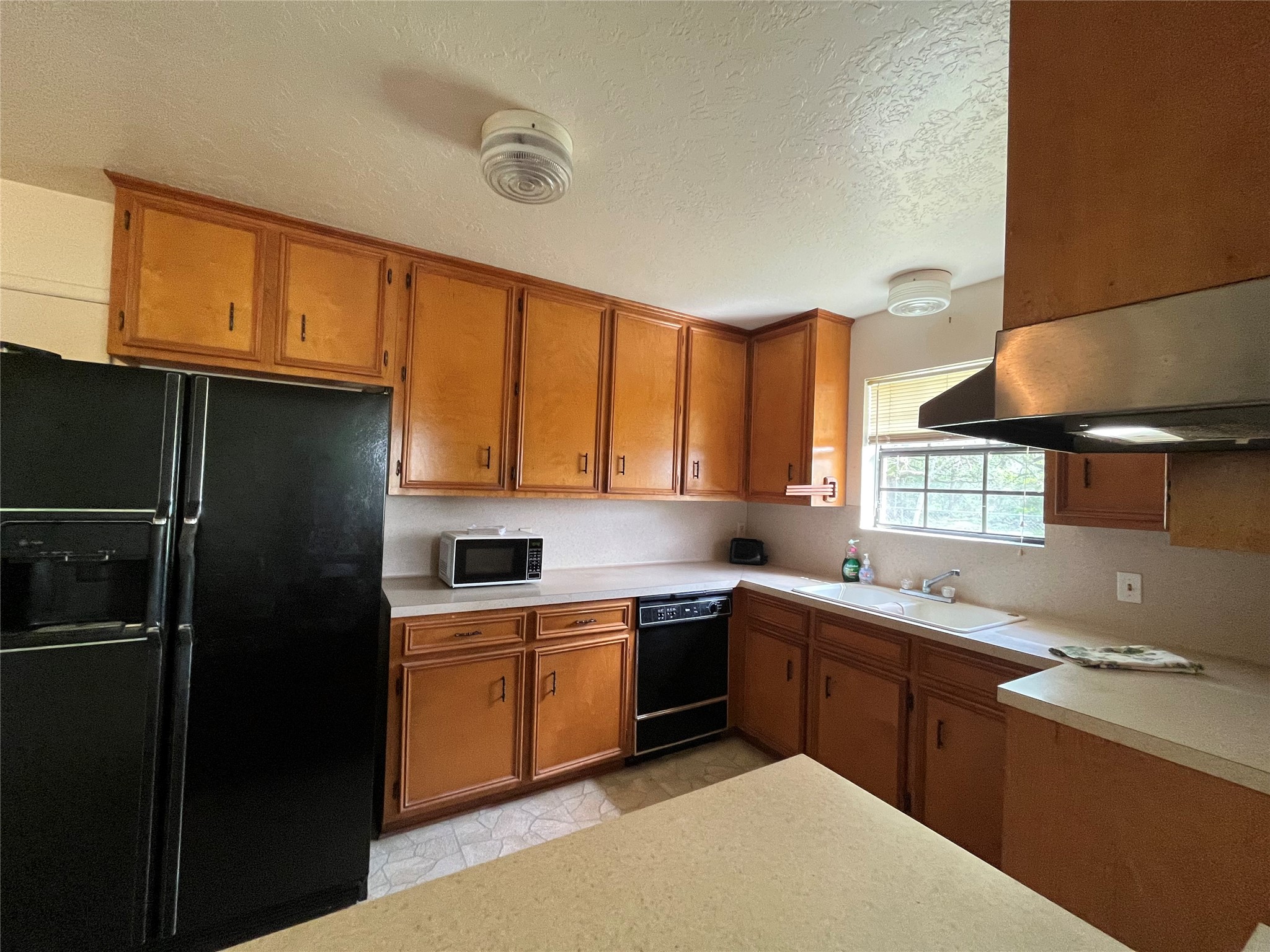 1475 Cr 16 Road Garwood, TX 77442 - Photo 18 of 43 a kitchen with a sink a refrigerator and cabinets