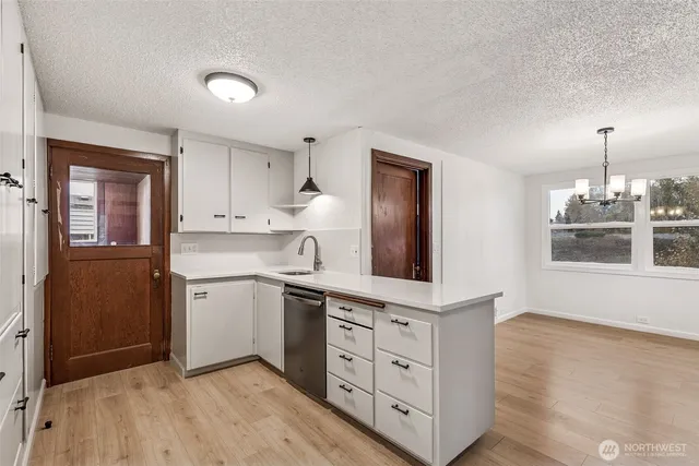 a kitchen with a white cabinets and sink